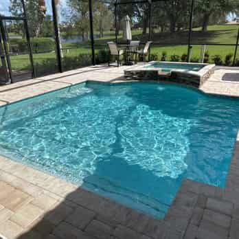 Pool with elevated spa and lake view — Southwest FL