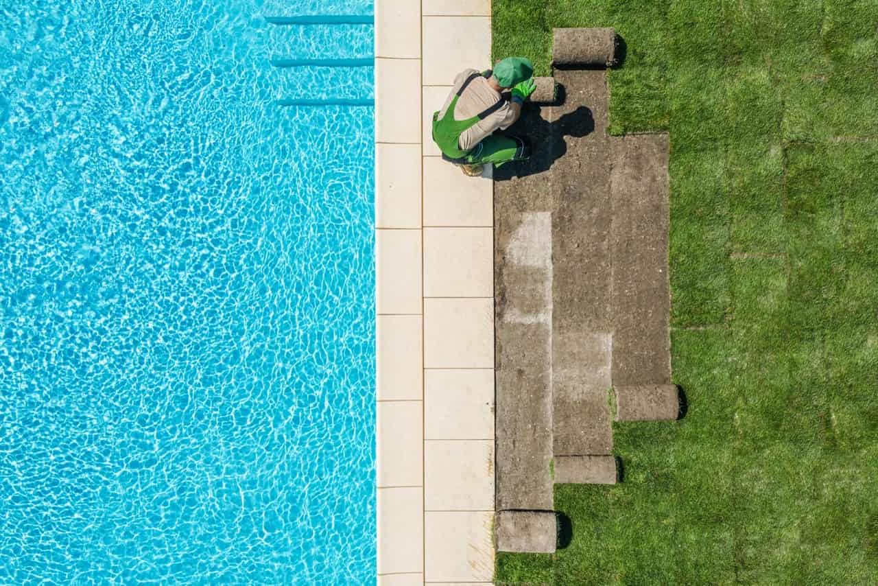 Landscaper installing sod next to custom pool — Venice, FL